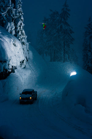 Open image in slideshow, Dana Flahr throwing a very large lawn dart front flip over the Mt. Baker road gap at dusk
