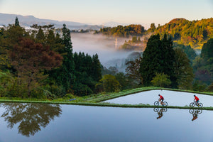 Scott Laughland and KC Deane mountian biking through the scenic rice paddies of Tokamachi